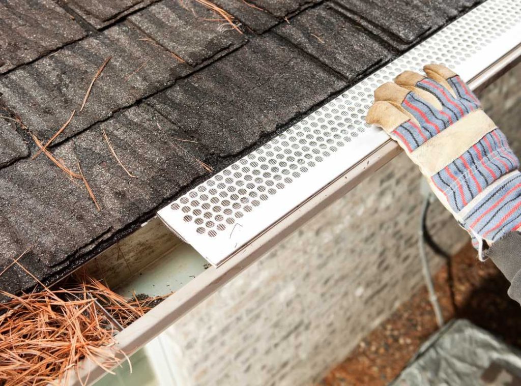 installing a gutter guard.