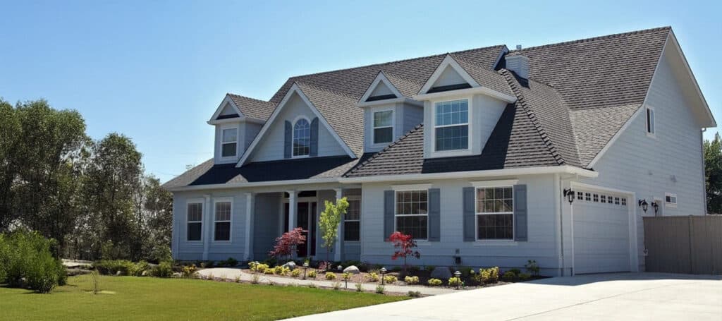 A suburban home with a newly installed dark shingle roof in Albany.